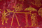 Luang Prabang, Laos - Wat Pa Phai the 'Bamboo Forest Monastery'. Inside gilded stencils against a red lacquered background depict scenes from the Buddhist hell. 